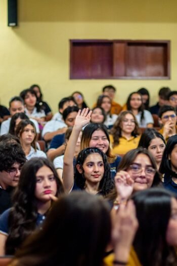 A diverse group of students attentively participating in a lively classroom setting.